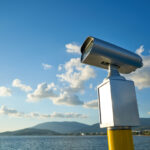 الرئيسية modern binoculars with city background 1 scaled.jpg